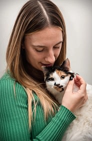 Woman-holding-calico-cat woman holding calico cat